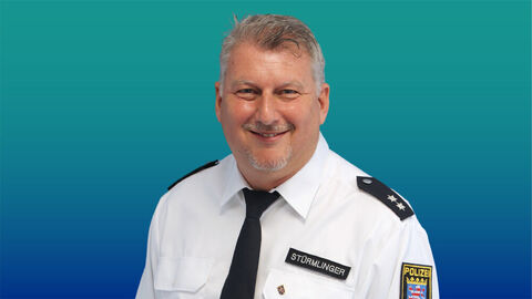 Polizeibeamter mit kurzen hellen Haaren im weißen Diensthemd mit Krawatte