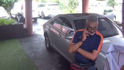 Unbekannter Täter stet telefonierend an einem Fahrzeug