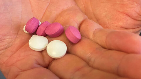 Symbolbild ausgestreckte Hand mit psychoaktiven Pillen