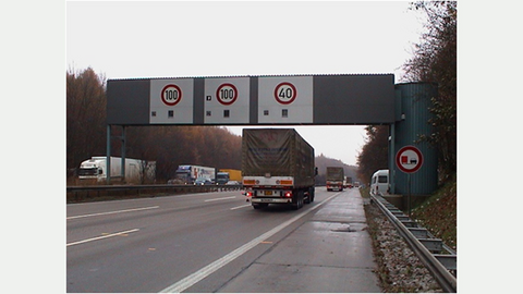 Das Bild zeigt eine Geschwindigkeitsmessstelle auf einer dreispurigen Autobahn. 